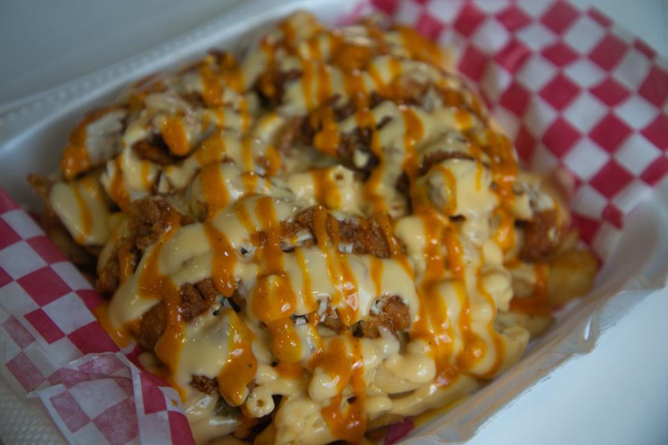 The XXX Loaded Fries are displayed at Hot Chicken Run Saturday, Aug. 26, 2023. The savory dish contains French fries and chicken tenders topped with macaroni and cheese and drizzled in a selected sauce.