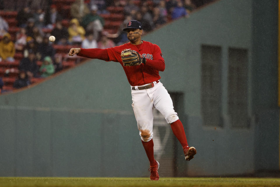 BOSTON, MA - OCTOBER 5: Xander Bogaerts #2 of the Boston Red Sox throws out a runner during the seventh inning against the Tampa Bay Rays at Fenway Park on October 5, 2022 in Boston, Massachusetts. (Photo By Winslow Townson/Getty Images)