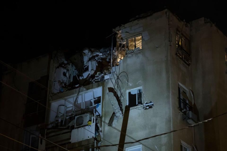A building was damaged after being hit by a rocket fired from Gaza strip on Saturday in Tel Aviv.
