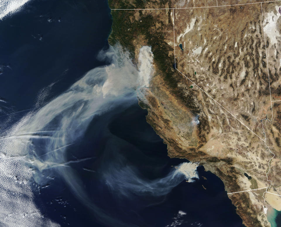 Massive plumes of smoke billow Friday over the state. (Photo: NASA)