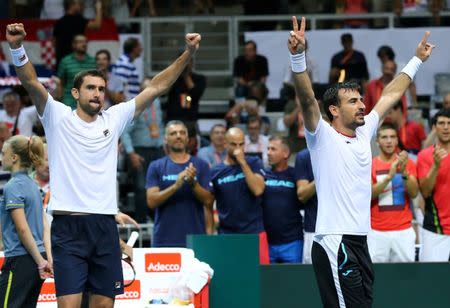 Tennis - Croatia v France - Davis Cup Semi Final - Kresimir Cosic Hall, Zadar, Croatia - 17/9/16 Croatia's Marin Cilic and Ivan Dodig react after winning their men's doubles match against France's Pierre-Hugues Herbert and Nicolas Mahut. REUTERS/Antonio Bronic