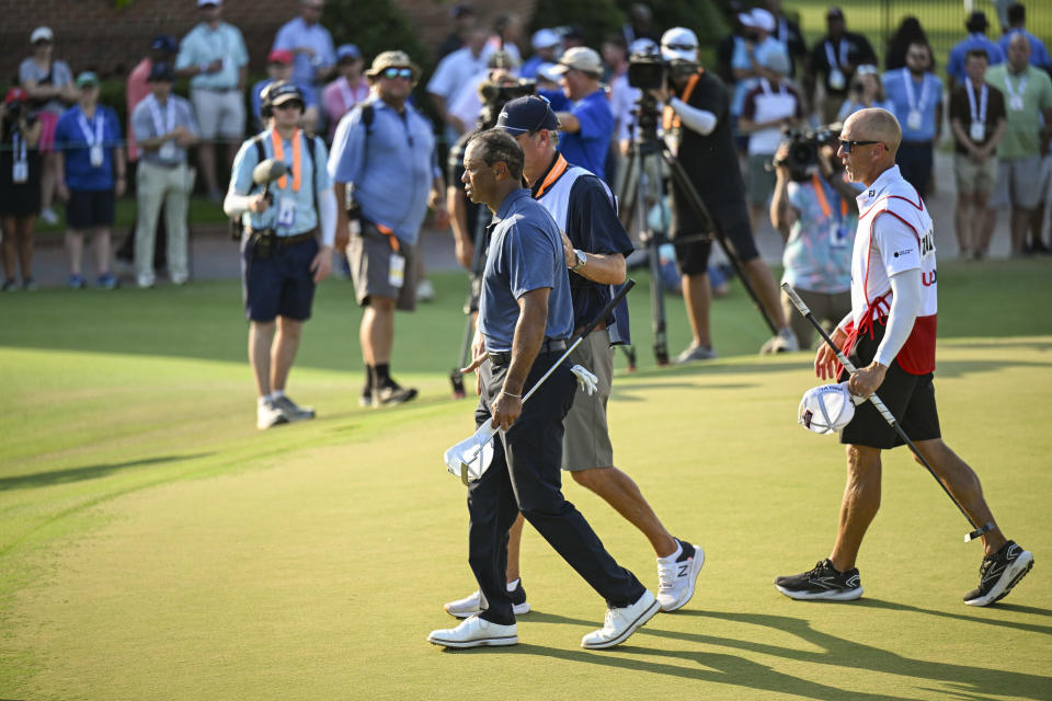 PINEHURST, NORTH CAROLINA - JUNE 14:  Tiger Woods walks with caddie Lance Bennett after finishing play on the 18th hole green during the second round of the U.S. Open on the No. 2 Course at Pinehurst Resort on June 14, 2024, in Pinehurst, North Carolina. (Photo by Keyur Khamar/PGA TOUR via Getty Images)