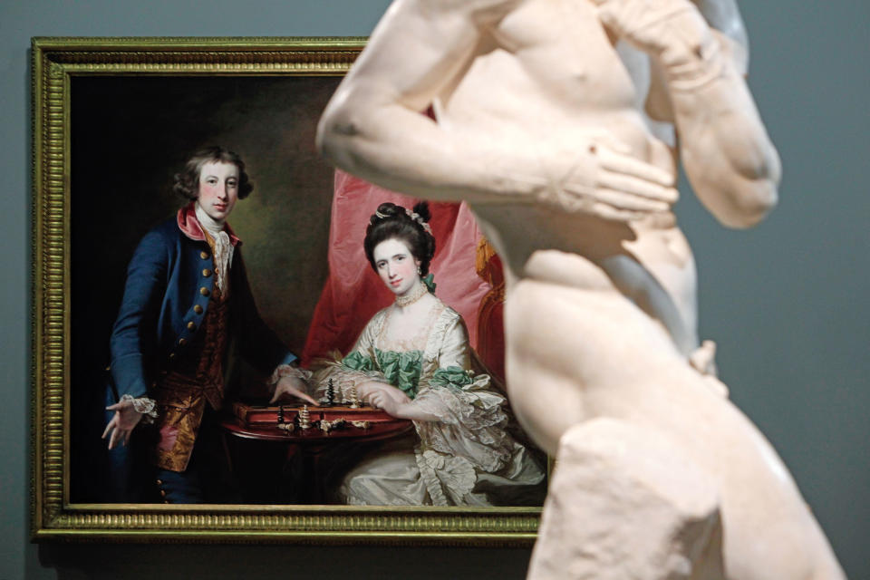 Francis Cotes' painting named "Portrait of William Welby and his wife Penelope Playing Chess" (1769) and Antonio Canova's sculpture named "The Pugilists Creugas and Damoxenos" (1797-1803) are displayed as part of the exhibition "Louvre Abu Dhabi. Birth of a Museum", at the Louvre museum, in Paris, Monday, April 28, 2014. The Louvre Abu Dhabi, the Persian Gulf’s first ever world museum, will open its doors in December 2015 in the arid Arab federation. Several thousand kilometers away on Tuesday the Louvre in Paris previewed the art that the Abu Dhabi project has acquired since 2009 for the first time to a European audience. (AP Photo/Thibault Camus)