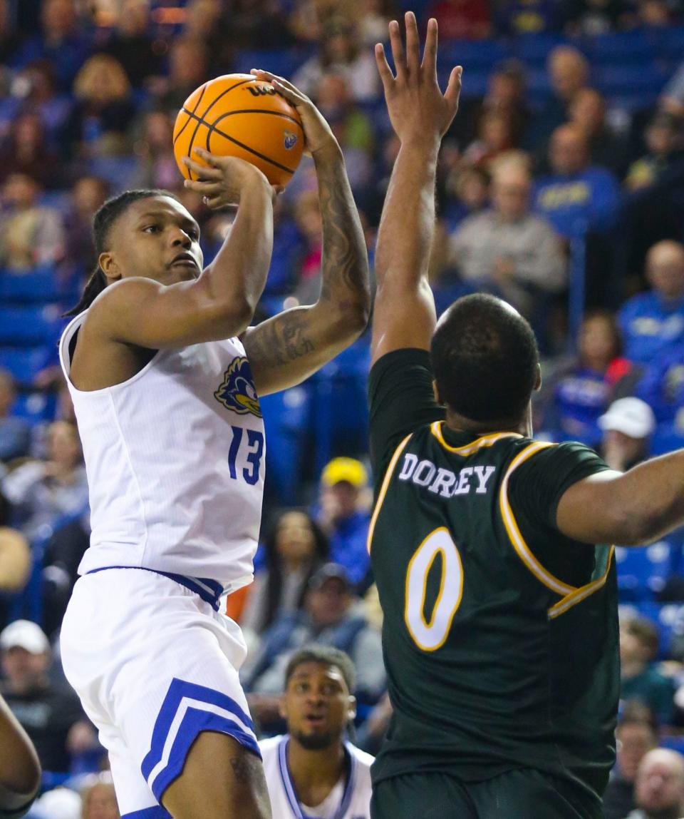 Delaware's Jyare Davis shoots over William and Mary's Caleb Dorsey in the second half of Delaware's 69-58 win at the Bob Carpenter Center, Saturday, Feb. 10, 2024.