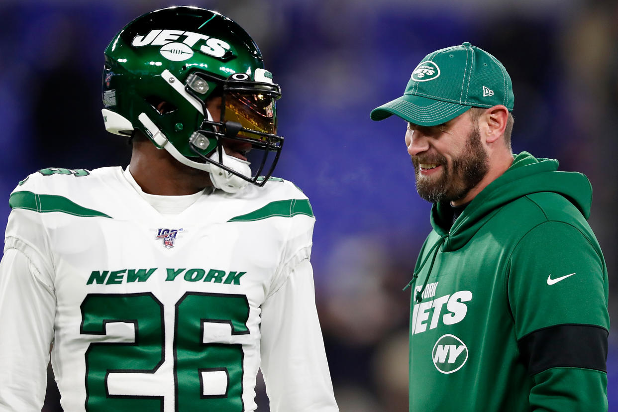 Head coach Adam Gase of the New York Jets and running back Le'Veon Bell talk before the game.