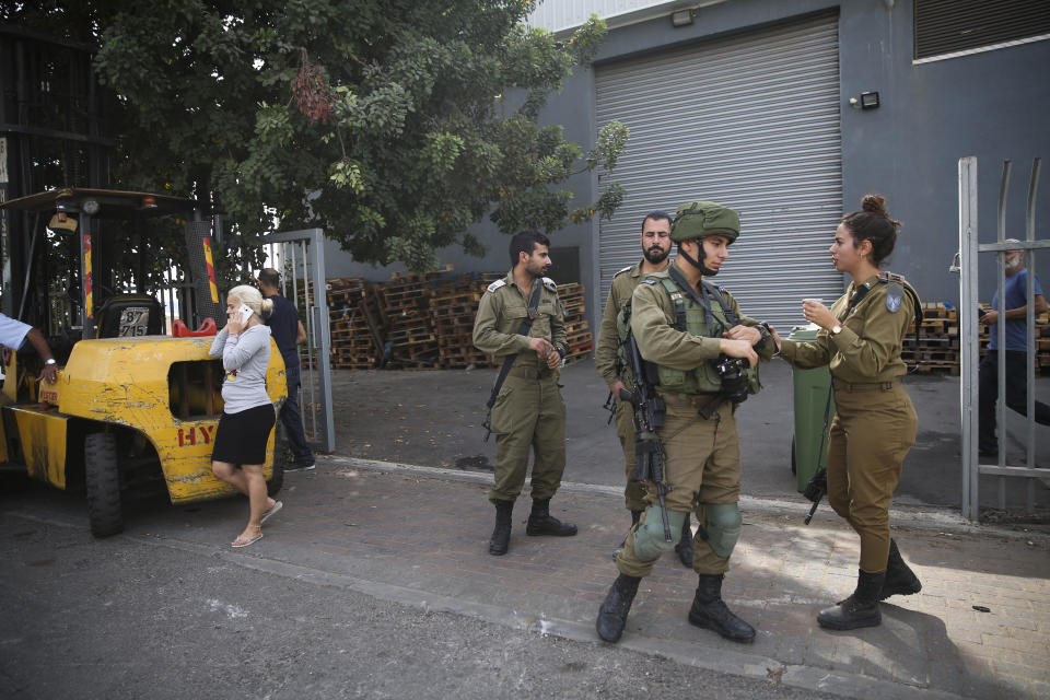 Israeli security forces stand at the entrance of Barkan industrial zone in the West Bank Sunday, Oct. 7, 2018. A Palestinian attacker opened fire at joint Israeli-Palestinian industrial zone in the West Bank Sunday, killing two Israelis and seriously wounding a third, the military said. (AP Photo/Oded Balilty)