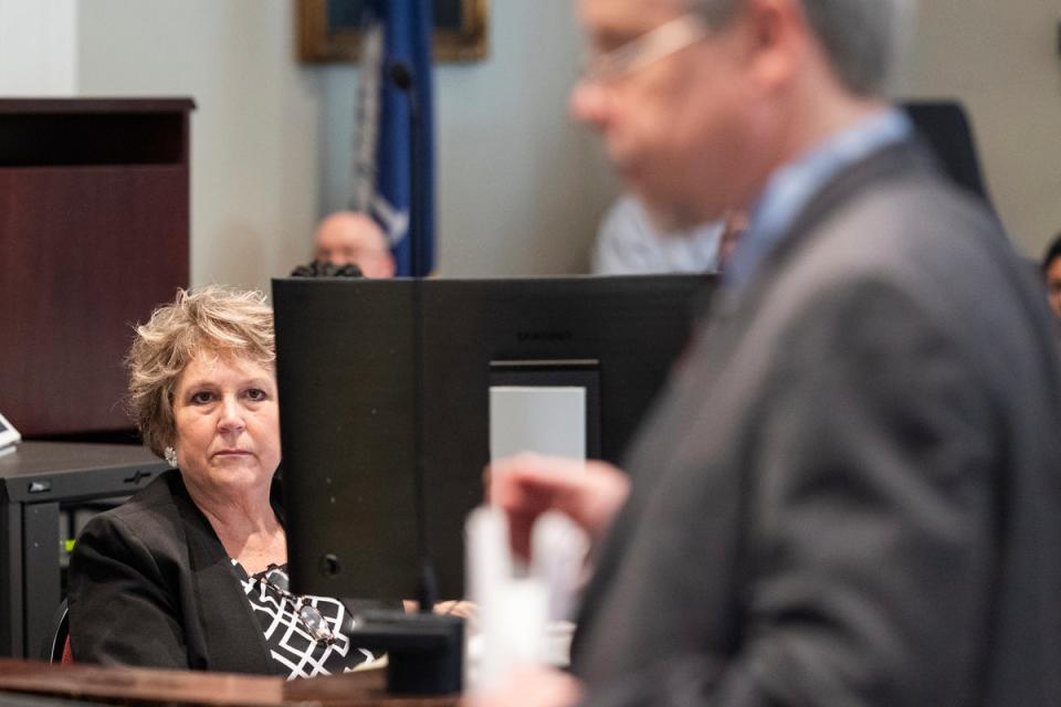 Colleton County Clerk of Court Rebecca Hill listens as Prosecutor Creighton Waters makes closing arguments in Alex Murdaugh trial in March