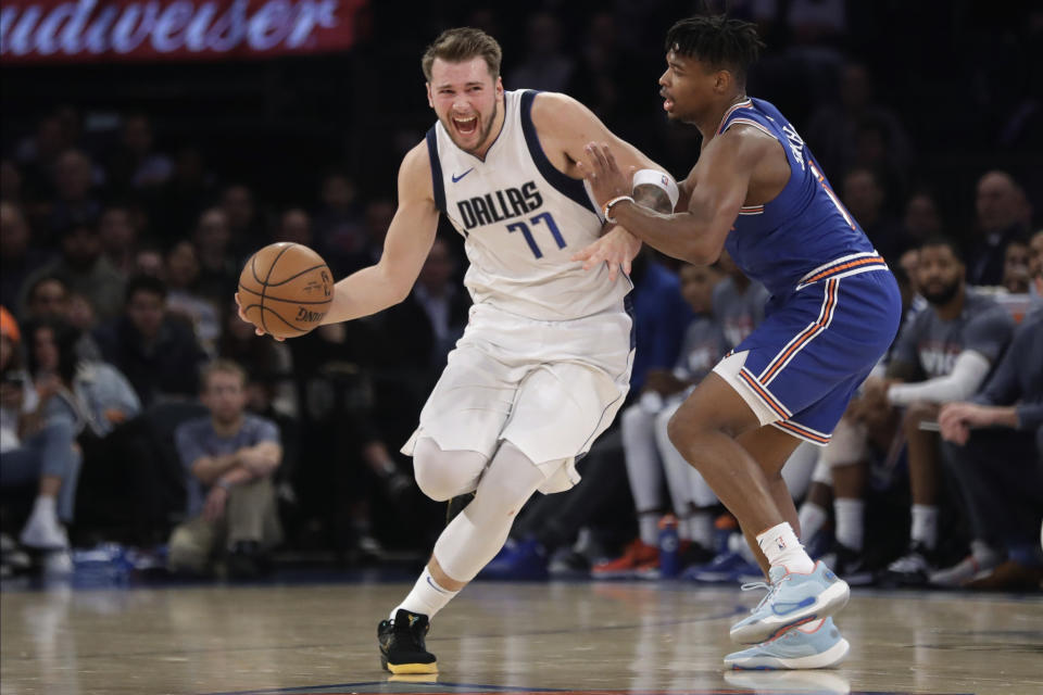 New York Knicks' Dennis Smith Jr., right, defends against Dallas Mavericks' Luka Doncic (77) during the first half of an NBA basketball game Thursday, Nov. 14, 2019, in New York. (AP Photo/Frank Franklin II)