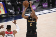 Memphis Grizzlies guard De'Anthony Melton (0) shoots against Washington Wizards guard Russell Westbrook (4) during the first half of an NBA basketball game, Tuesday, March 2, 2021, in Washington. (AP Photo/Nick Wass)