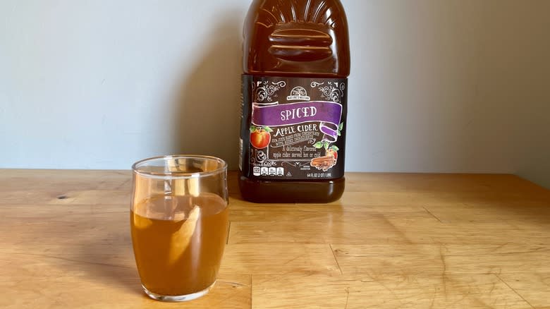 Glass cup of cider with bottle of Nature's Nectar spiced cider