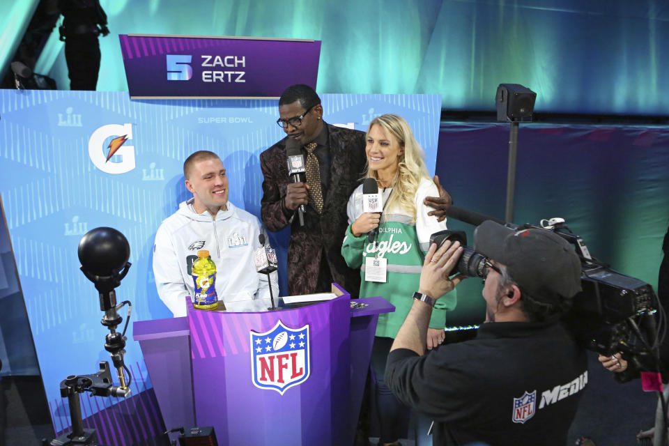 From (L-R) Philadelphia Eagles tight end Zach Ertz is interviewed by Michael Irvin, and Zach’s wife Julie Ertz during opening night for the NFL Super Bowl 52 football game at Xcel Energy Center on Monday, Jan. 29, 2018, in St. Paul, Minn. (AP Photo/Gregory Payan)