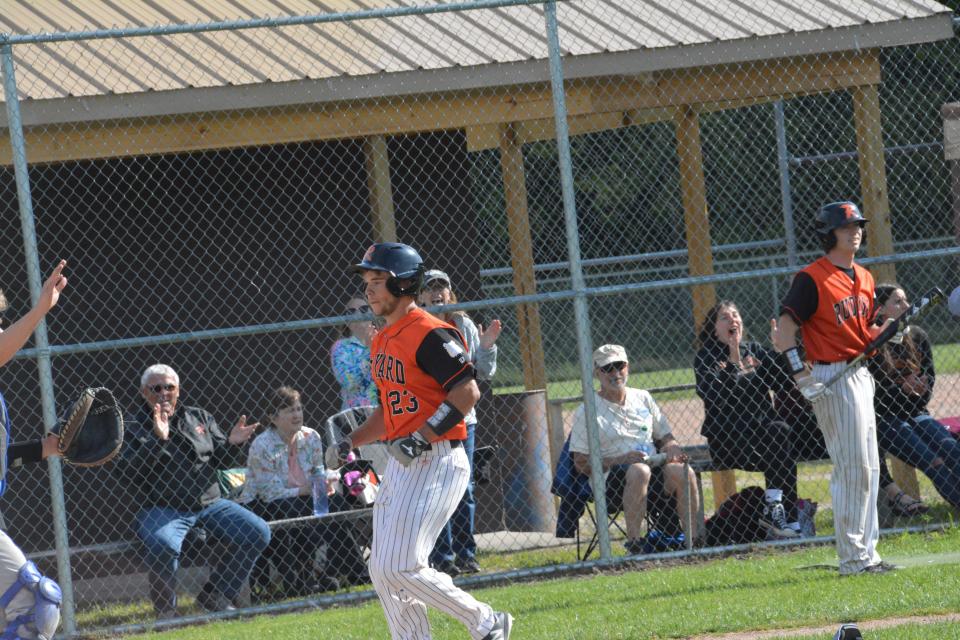 Austin Warner of Rudyard (23) scores a run during a regional game against Inland Lakes at Pellston. Warner was named All-State honorable mention.