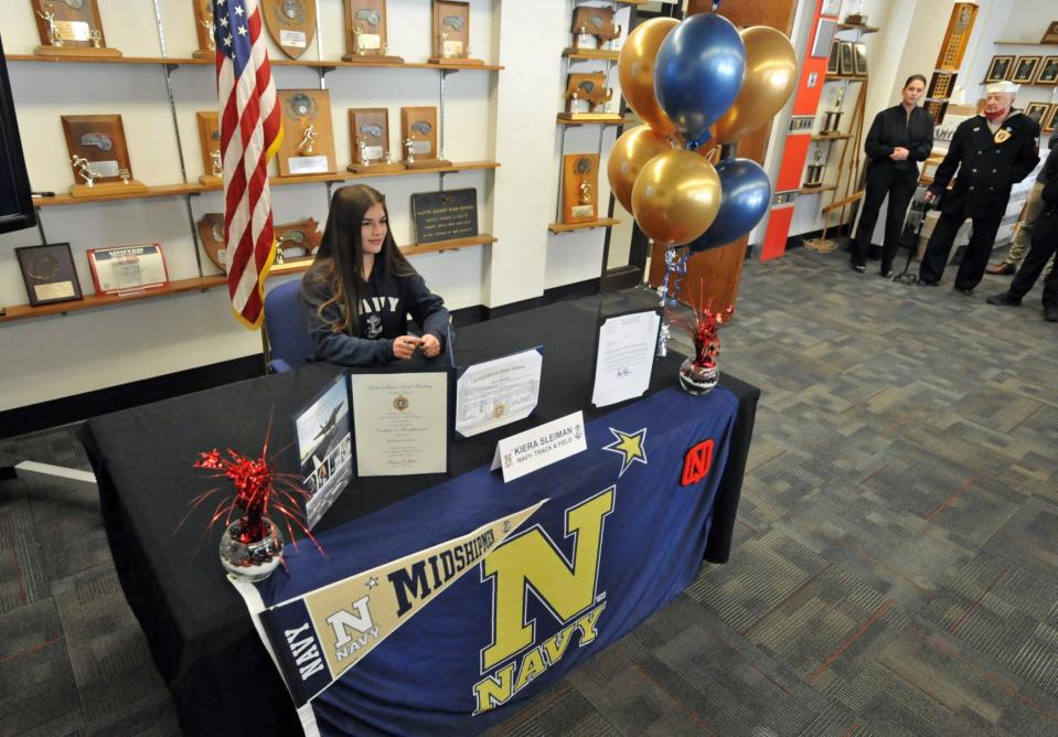 North Quincy High School senior and student-athlete Kiera Sleiman prepares to sign her acceptance certificate to the United States Naval Academy during a ceremony at North Quincy High School on Friday, April 29, 2022.