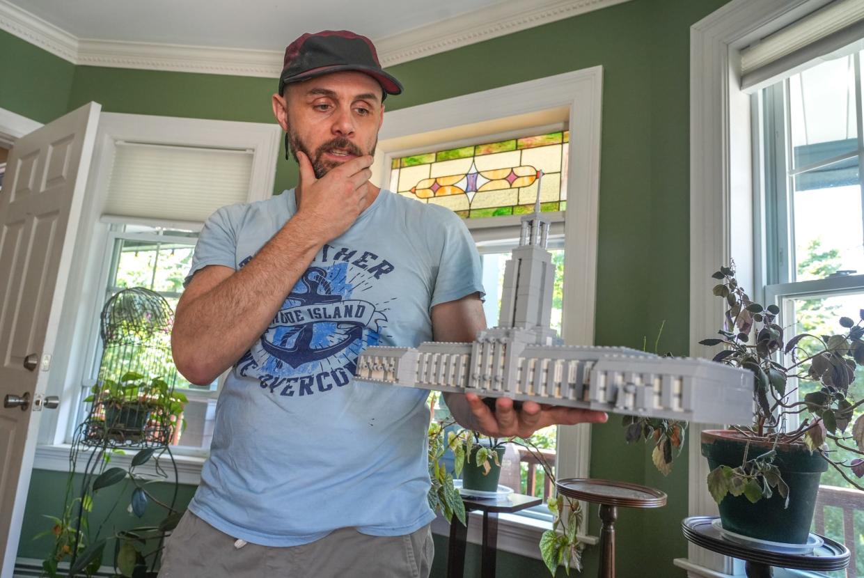 Andrew Grover with a Lego version of Pawtucket City Hall, one of his replicas of Rhode Island's iconic buildings.