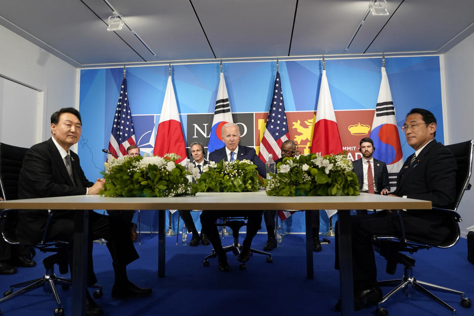 FILE - President Joe Biden, center, meets with South Korea's President Yoon Suk Yeol, left, and Japan's Prime Minister Fumio Kishida during the NATO summit in Madrid, on June 29, 2022. The leaders of South Korea and Japan will meet next week on the sidelines of the U.N. General Assembly in New York, Seoul officials said Thursday, Sept. 15, 2022, in what would be the countries’ first summit in nearly three years amid disputes over history.(AP Photo/Susan Walsh, File)