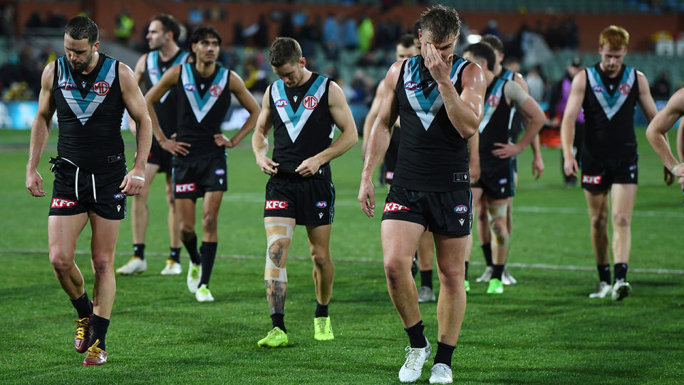 Port Adelaide players walk off the oval after their loss to Richmond.