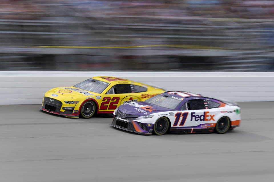 Denny Hamlin (11) and Joey Logano (22) race in the NASCAR Cup Series auto race at the Michigan International Speedway in Brooklyn, Mich., Sunday, Aug. 7, 2022. (AP Photo/Paul Sancya)