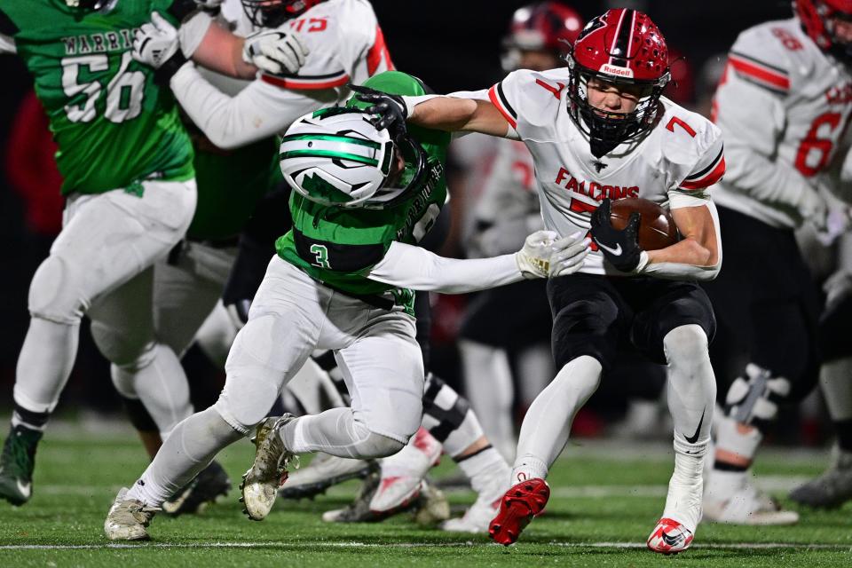 Jefferson's Trent Hodge fights off West Branch's Nick Love during the second half of their playoff game, Saturday night at Bo Rein Stadium in Niles.