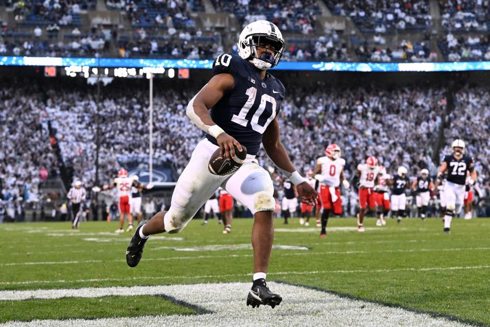 FILE - Penn State running back Nicholas Singleton (10) scores a touchdown against Maryland during the first half of an NCAA college football game, Saturday, Nov. 12, 2022, in State College, Pa. James Franklin hasn't hesitated to play freshmen in big roles in the past and this season is no different. The Nittany Lions have gotten big contributions from running backs Kaytron Allen and Nick Singleton while hard-hitting linebacker Abdul Carter has emerged as one of the team's best players on defense. (AP Photo/Barry Reeger, File)