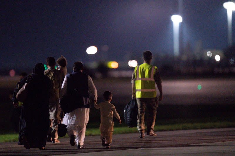 British nationals and Afghan evacuees depart a flight from Afghanistan at RAF Brize Norton