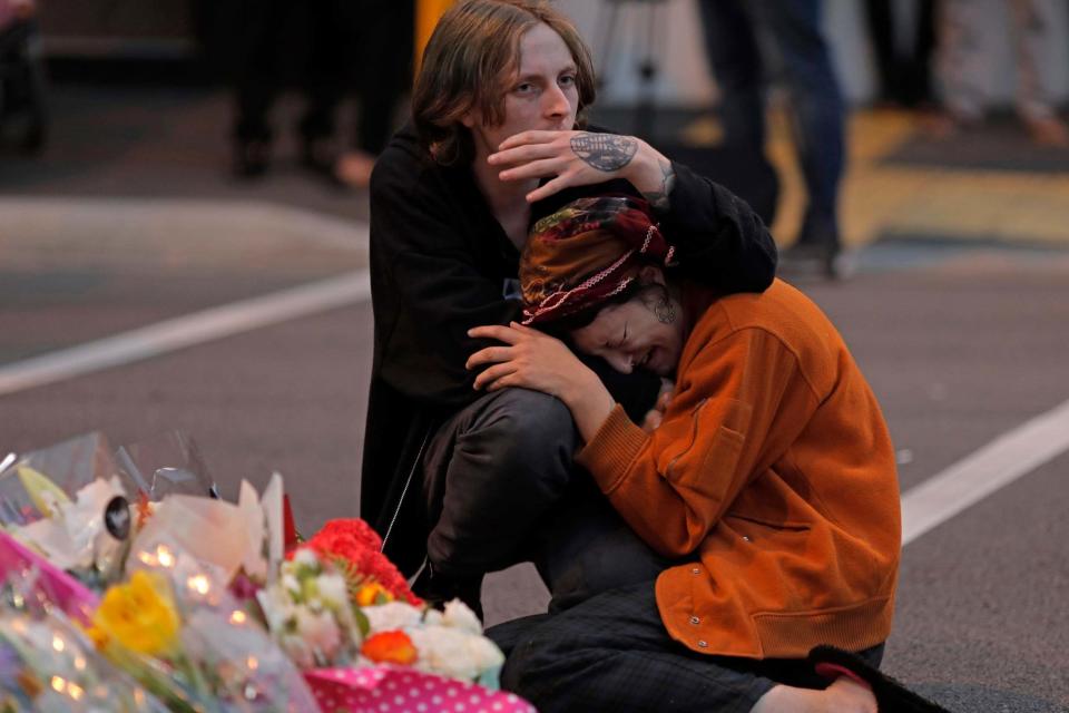 Mourners pay their respects at a memorial near the Masjid Al Noor mosque in Christchurch (AP)