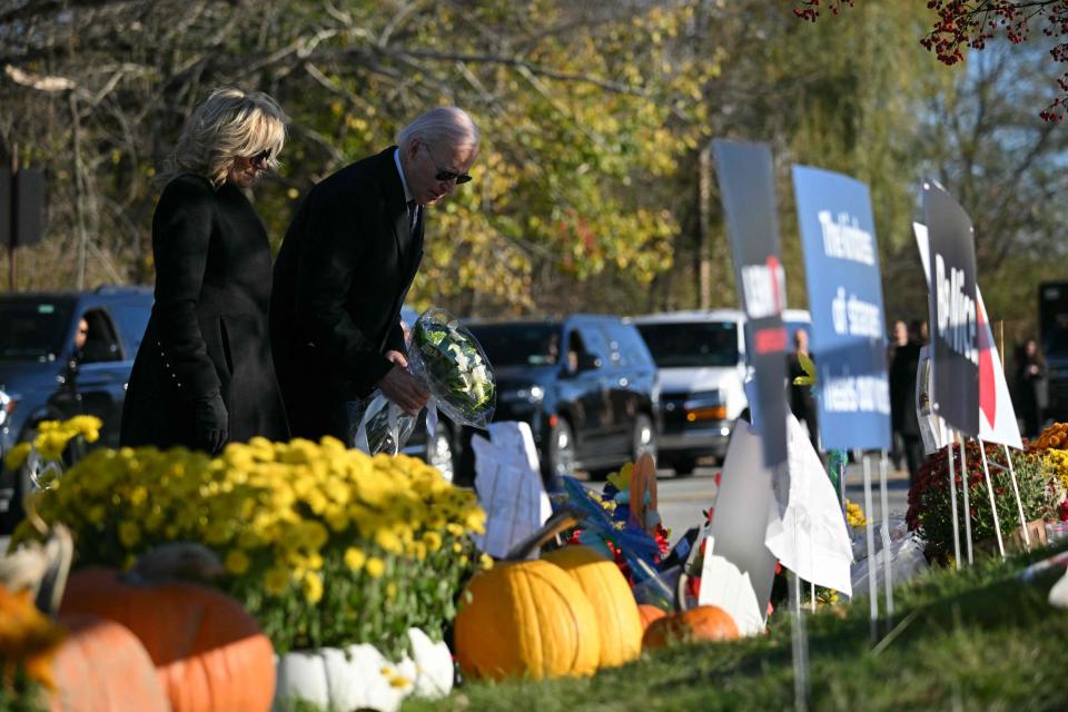 US President Joe Biden and First Lady Jill Biden pay their respects outside Schemengees Bar and Grille in Lewiston, Maine, on November 3, 2023 following a mass shooting on October 25.
