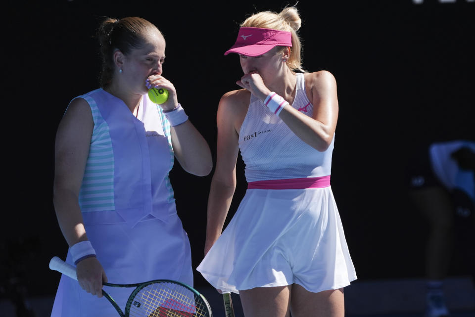 Jelena Ostapenko, left, of Latvia and Lyudmyla Kichenok of Ukraine talk during the women's doubles final against Hsieh Su-Wei of Taiwan and Elise Mertens of Belgium at the Australian Open tennis championships at Melbourne Park, in Melbourne, Australia, Sunday, Jan. 28, 2024. (AP Photo/Andy Wong)