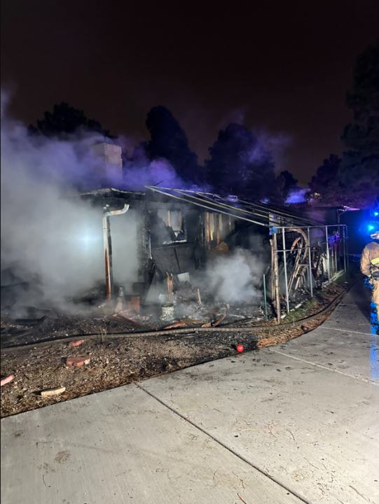 Smoke comes from a home damaged by fire