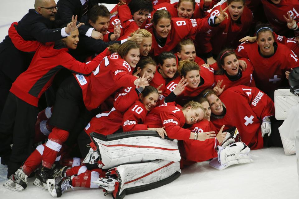 Team Switzerland poses for a picture after their 4-3 win over Sweden in the women's bronze medal ice hockey game at the 2014 Winter Olympics, Thursday, Feb. 20, 2014, in Sochi, Russia. (AP Photo/Julio Cortez)