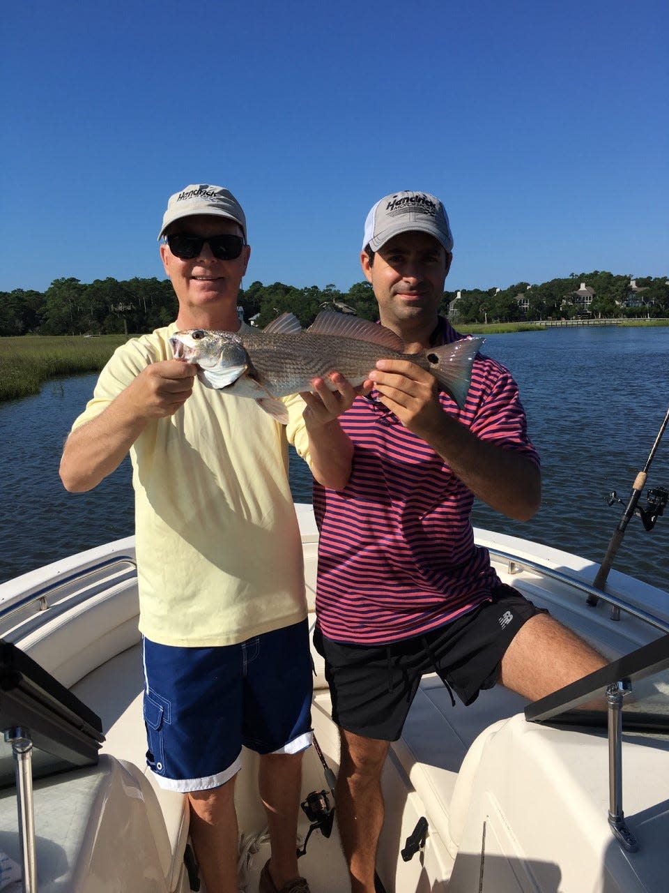 Former Gov. Mike Easley, left, and son, Michael Easley Jr., who now serves as the U.S. attorney for the Eastern District, shows off their catch.