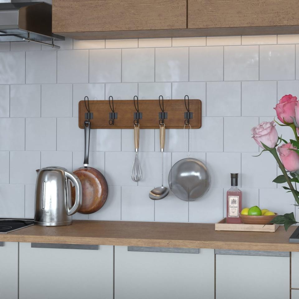 Kitchen wall mount with pots and pans hung on it.