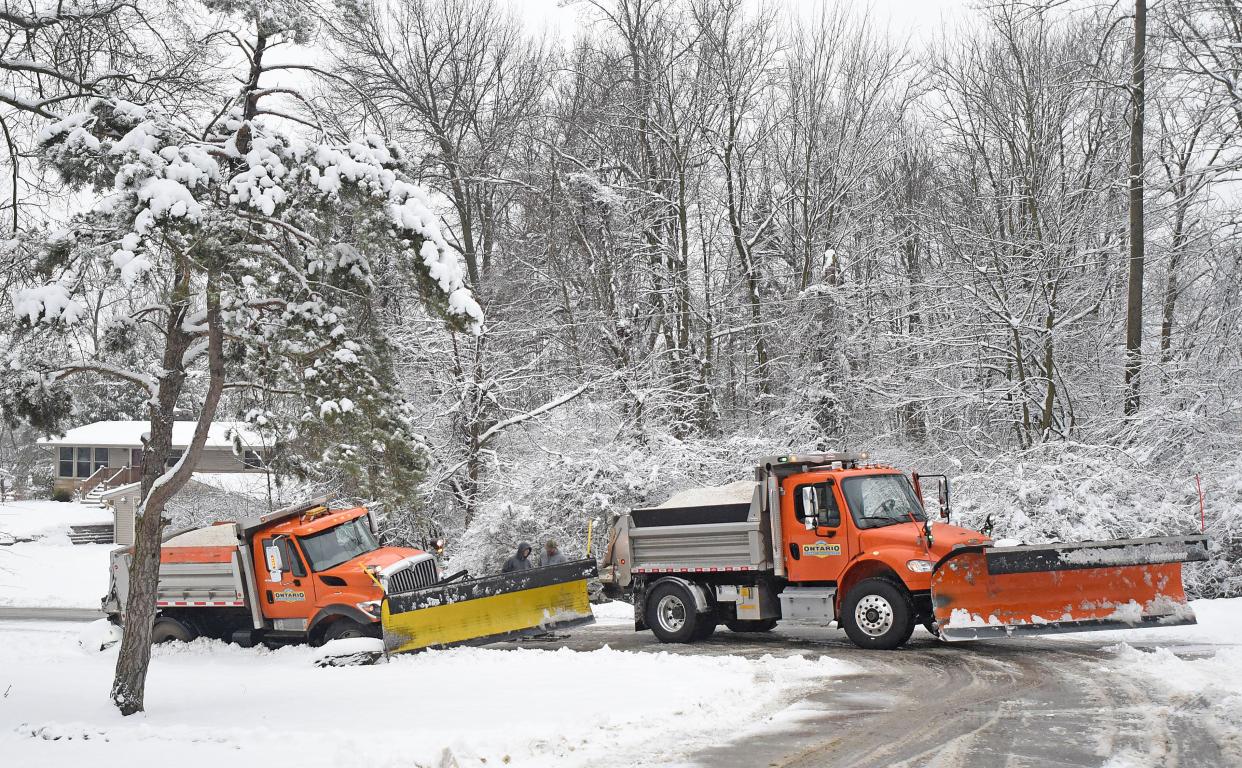 Ontario snow plow drivers work to free one of the vehicles stuck in the culvert on Grace Avenue on Wednesday morning.