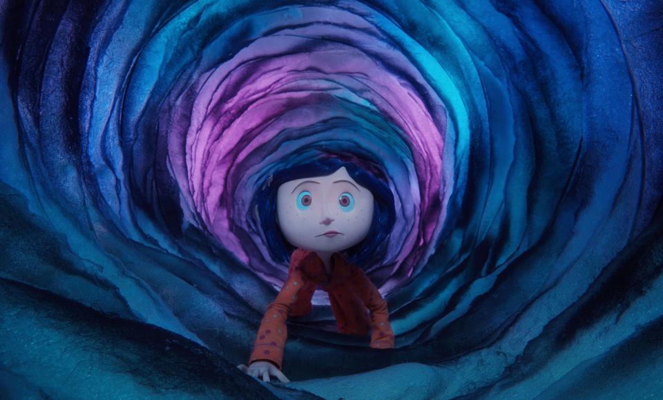 A curious girl (voiced by Dakota Fanning) travels through a portal between worlds in "Coraline."