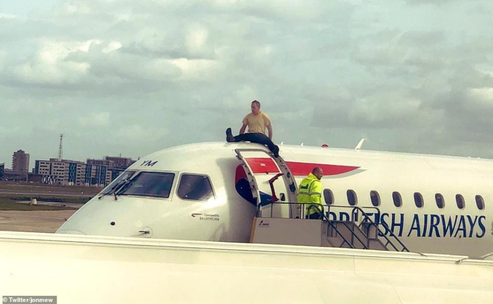 Extinction Rebellion activist James Brown on top of a plane on the morning of October 10 2019 during a protest against flying at London City Airport (Extinction Rebellion/PA) (PA Media)