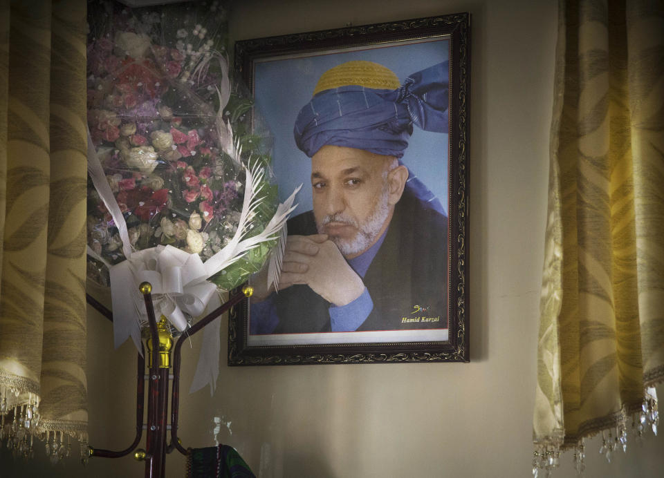 A picture of Afghanistan's President Hamid Karzai hangs in a police chief's office, in Kabul, Afghanistan, Sunday, March 30, 2014. Karzai inherited a broken country when the Americans and their allies chose him more than 12 years ago as a leader they hoped could cross ethnic lines, embrace former enemies and bring Afghans together. As he prepares to leave office, Afghanistan has made great strides yet remains hobbled by a resilient Taliban insurgency and fears of a return to civil war. (AP Photo/Anja Niedringhaus)