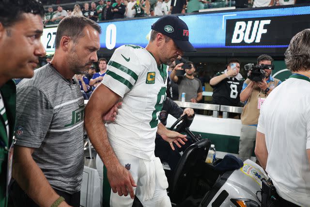 <p>Elsa/Getty</p> Aaron Rodgers being helped off the field on Monday night