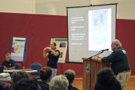 From left, Civil Defense Administrator Talmadge Magno, translator Carrie Kaufmann, and Ken Hon, Hawaiian Volcano Observatory scientist-in-charge, speak to a crowd about the potential threat of a Mauna Loa eruption at the local gymnasium in Pahala, Hawaii, on Oct. 27, 2022. The ground is shaking and swelling at Mauna Loa, the largest active volcano in the world, indicating that it could erupt. Scientists say they don't expect that to happen right away but officials on the Big Island of Hawaii are telling residents to be prepared. (AP Photo/Megan Moseley)