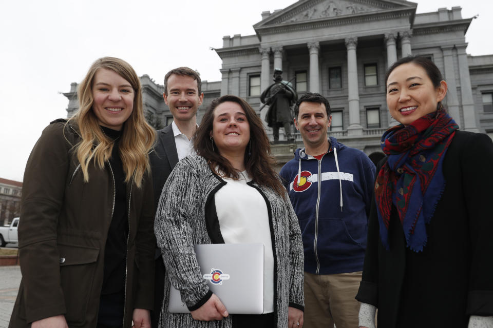 In this Tuesday, Jan. 21, 2020, photograph, from left, Stephanie Cain, Matthew McAllister, Janell Schafer, Kelly Taylor and Yeri Kim, all members of the Colorado Digital Service, are shown outside the State Capitol in downtown Denver. (AP Photo/David Zalubowski)