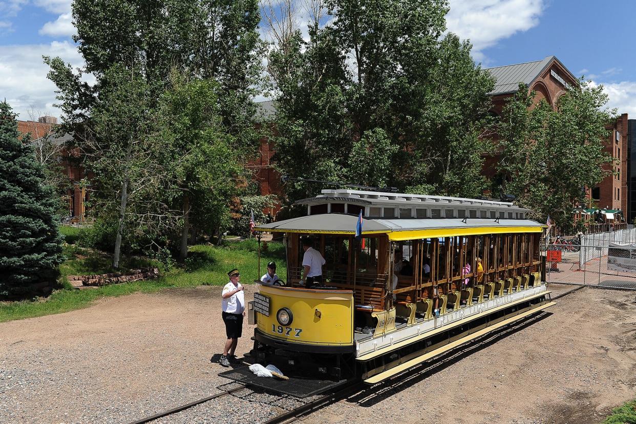 Bob Westgate, one of the volunteers who operates the Platte Valley Trolley, boards the trolley at its starting point outside of REI in Denver, Colorado.