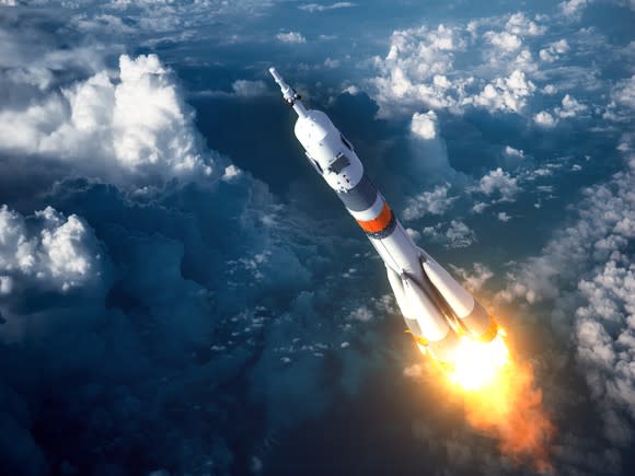 A rocket is shown from above, shooting into space