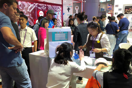 People visit a nail polish and nail printing booth at the China Import and Export Fair, also known as Canton Fair in Guangzhou, Guangdong province, China October 16, 2018. REUTERS/Sue-Lin Wong