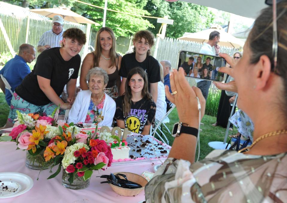 Family members gather around Jo Sharp, seated center, for a picture during her 100th birthday celebration at her Braintree home.