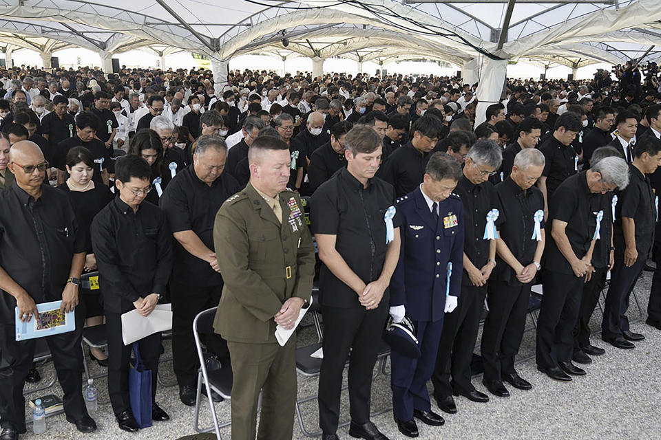 Attendees pray during a memorial ceremony for all war dead in Okinawa at the Peace Memorial Park in Itoman, Okinawa prefecture, southern Japan Friday, June 23, 2023. Japan marked the Battle of Okinawa, one of the bloodiest battles of World War II fought on the southern Japanese island, which ended 78 years ago. (Kyodo News via AP)