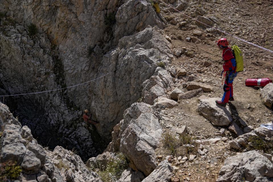 European Cave Rescue Association (ECRA) members, go down into the Morca cave during a rescue operation near Anamur, south Turkey, Friday, Sept. 8, 2023. American researcher Mark Dickey, 40, who fell ill almost 1,000 meters (more than 3,000 feet) below the entrance of a cave in Turkey, has recovered sufficiently enough to be extracted in an operation that could last three or four days, a Turkish official was quoted as saying on Friday. (AP Photo/Khalil Hamra)