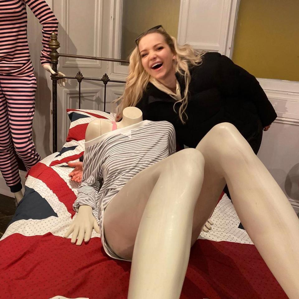 Dove Cameron poses by a mannequin