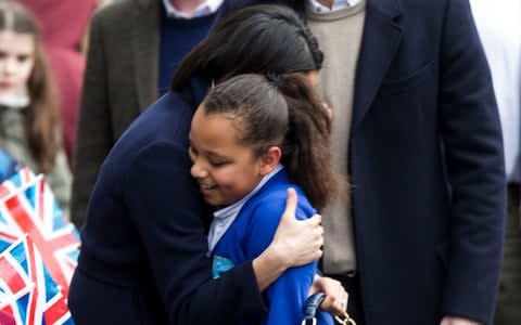 Meghan Markle hugs a schoolgirl in Birmingham - Credit: Heathcliff O'Malley for The Telegraph 