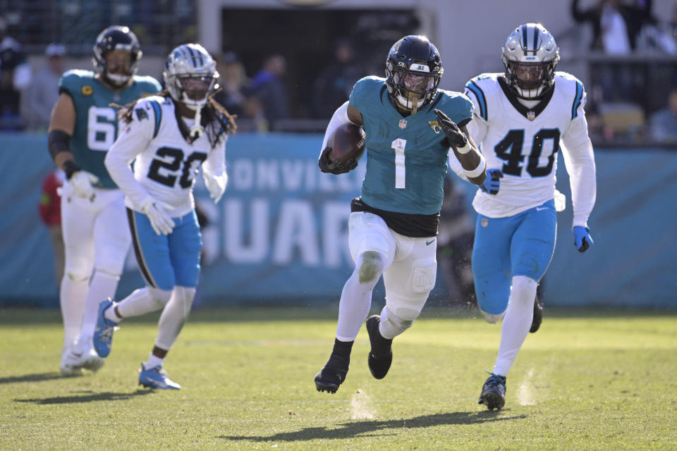 Jacksonville Jaguars running back Travis Etienne Jr. runs for a touchdown against the Carolina Panthers during the second half of an NFL football game Sunday, Dec. 31, 2023, in Jacksonville, Fla. (AP Photo/Phelan M. Ebenhack)