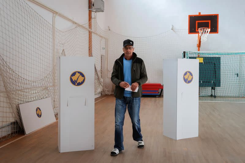 A Kosovo Albanian man prepares to vote at a polling station in the village of Qabra