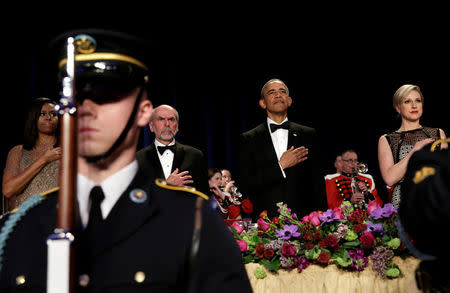 U.S. President Barack Obama and First lady Michelle Obama (L) stand during a presentation of colors at the White House Correspondents Association's annual dinner in Washington, U.S., April 30, 2016. REUTERS/Yuri Gripas