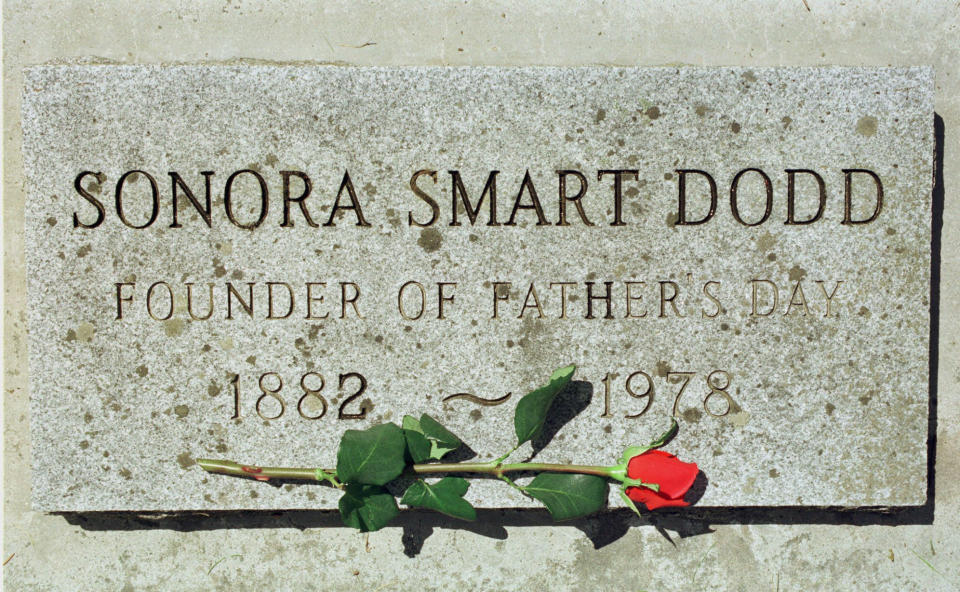 FILE - A rose lies on a grave marker of Sonora Smart Dodd at Greenwood Memorial Terrace on June 16, 1999, in Spokane, Wash. Dodd is known as the founder of the first celebration of Father's Day in 1910. Sonora Smart Dodd lobbied local church and public officials for its creation. In the years that followed, Father's Day grew to become an international event and Dodd lived to see President Richard Nixon declare it an official U.S. holiday in 1972. (AP Photo/Jeff T. Green, File)